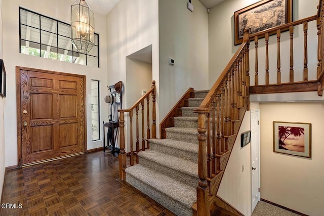 2025 Rosemont Ave Unit 2, Pasadena, CA 91103 - foyer with a towering ceiling, stairs, baseboards, and a chandelier