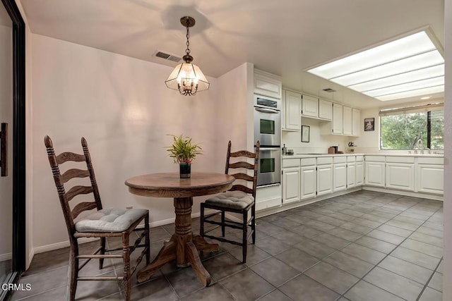 2025 Rosemont Ave Unit 2, Pasadena, CA 91103 - dining area featuring dark tile patterned flooring and a chandelier