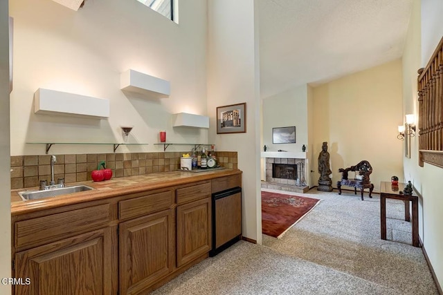 2025 Rosemont Ave Unit 2, Pasadena, CA 91103 - kitchen with a sink, light carpet, tasteful backsplash, brown cabinetry, and a towering ceiling