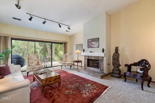 2025 Rosemont Ave Unit 2, Pasadena, CA 91103 - carpeted living area featuring a tiled fireplace, track lighting, and a textured ceiling