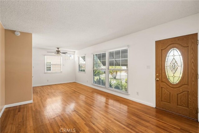 4660 Whitney Dr, El Monte, CA 91731 - entrance foyer featuring light wood-style flooring, ceiling fan, baseboards, and a textured ceiling