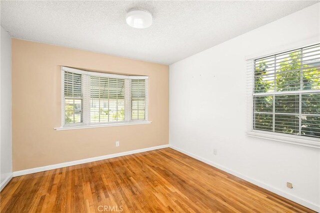 4660 Whitney Dr, El Monte, CA 91731 - unfurnished room featuring wood finished floors, a textured ceiling, and baseboards