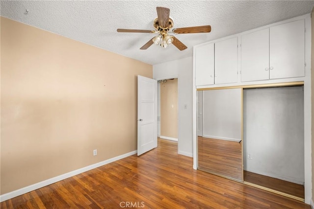 4660 Whitney Dr, El Monte, CA 91731 - unfurnished bedroom with wood finished floors, baseboards, a textured ceiling, a closet, and ceiling fan