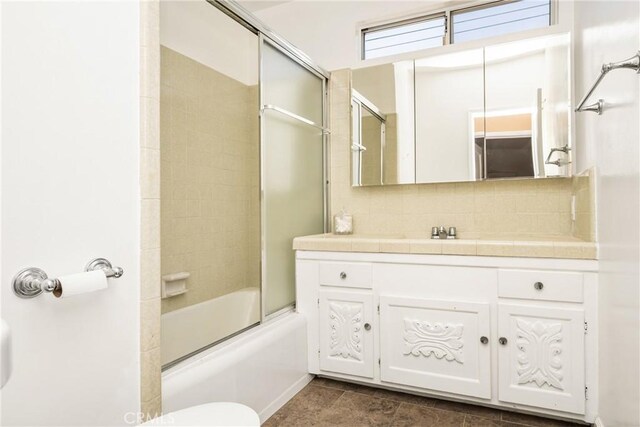 4660 Whitney Dr, El Monte, CA 91731 - bathroom with toilet, vanity, shower / bath combination with glass door, and decorative backsplash