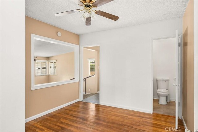 4660 Whitney Dr, El Monte, CA 91731 - empty room with a ceiling fan, wood finished floors, baseboards, and a textured ceiling