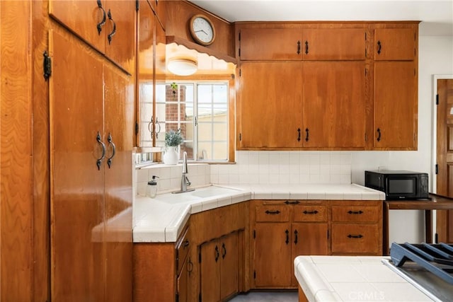 4660 Whitney Dr, El Monte, CA 91731 - kitchen featuring black microwave, a sink, decorative backsplash, and tile counters