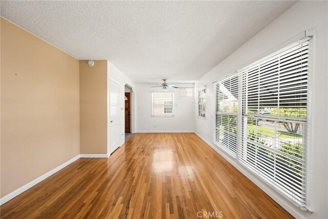 4660 Whitney Dr, El Monte, CA 91731 - spare room featuring light wood-style flooring, ceiling fan, baseboards, and a textured ceiling