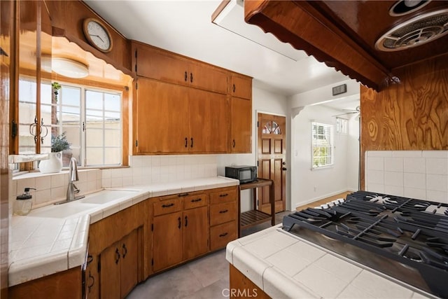 4660 Whitney Dr, El Monte, CA 91731 - kitchen with backsplash, a sink, tile countertops, black microwave, and brown cabinets
