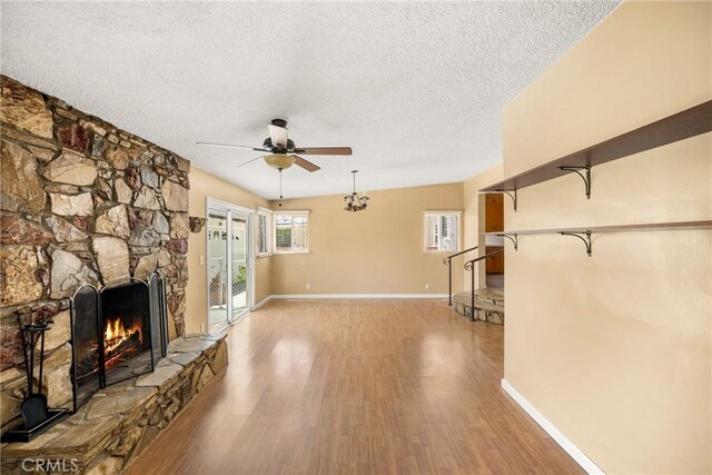 4660 Whitney Dr, El Monte, CA 91731 - unfurnished living room featuring a ceiling fan, a textured ceiling, light wood-style flooring, a fireplace, and baseboards
