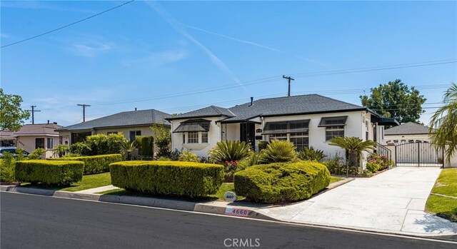 4660 Whitney Dr, El Monte, CA 91731 - view of front of home featuring a gate, driveway, and stucco siding