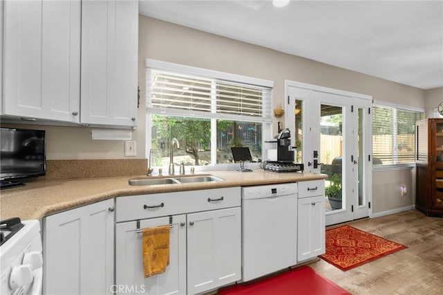 7052 Manhattan Dr, Riverside, CA 92506 - kitchen featuring white dishwasher, a sink, wood finished floors, light countertops, and white cabinetry