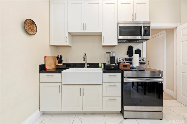 3845 10th St, Riverside, CA 92501 - kitchen with appliances with stainless steel finishes, light marble finish floors, a sink, baseboards, and dark countertops