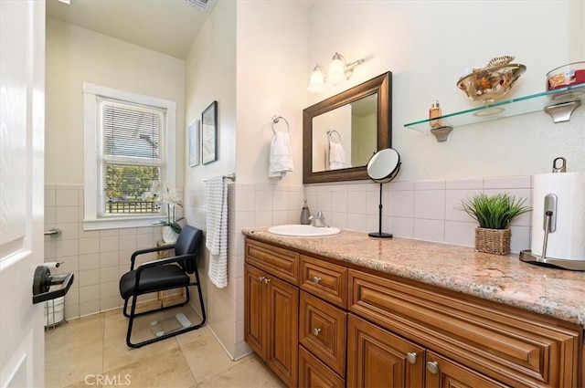 3845 10th St, Riverside, CA 92501 - bathroom with tile walls, tile patterned floors, vanity, and a wainscoted wall