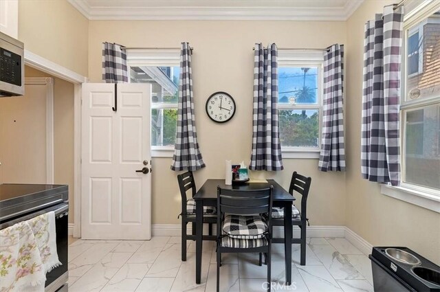 3845 10th St, Riverside, CA 92501 - dining room with light marble finish floors, crown molding, and baseboards