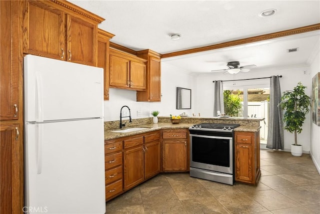4514 Jamestown, Yorba Linda, CA 92886 - kitchen featuring freestanding refrigerator, gas range, a sink, a peninsula, and brown cabinetry