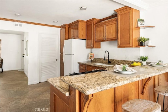 4514 Jamestown, Yorba Linda, CA 92886 - kitchen with a sink, brown cabinetry, freestanding refrigerator, open shelves, and light stone counters
