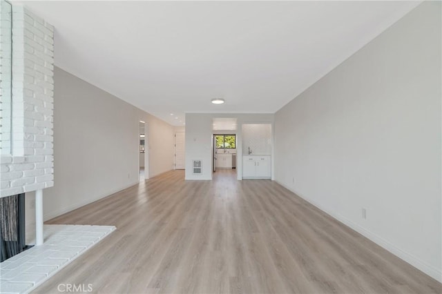 900 Cedar St Unit 308, El Segundo, CA 90245 - unfurnished living room featuring light wood-style flooring and a fireplace