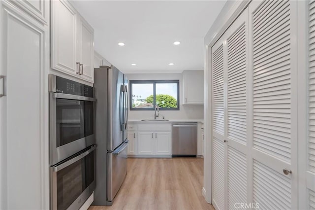 900 Cedar St Unit 308, El Segundo, CA 90245 - kitchen with appliances with stainless steel finishes, white cabinets, light wood-style flooring, light countertops, and recessed lighting