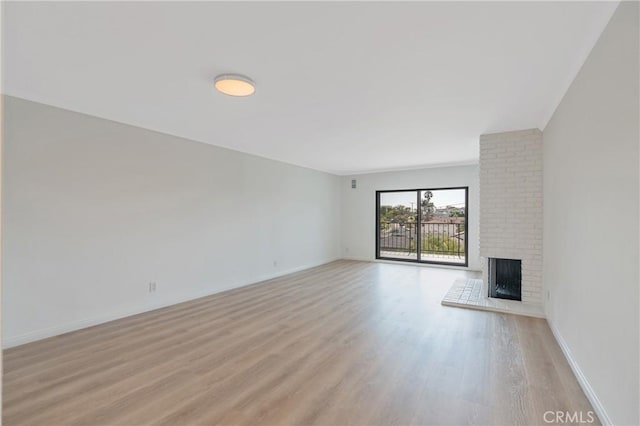 900 Cedar St Unit 308, El Segundo, CA 90245 - unfurnished living room featuring a fireplace and light wood-style floors