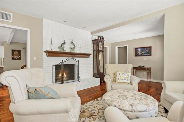 1330 S Center St, Redlands, CA 92373 - living area featuring wood finished floors, a fireplace, beamed ceiling, a textured ceiling, and baseboards