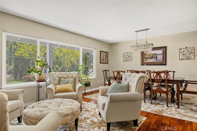 1330 S Center St, Redlands, CA 92373 - living room featuring wood finished floors, healthy amount of natural light, baseboards, and a textured ceiling