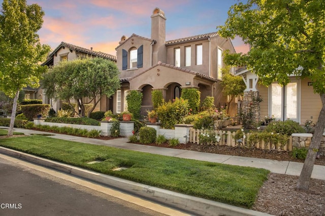 1315 Donegal Way, Oxnard, CA 93035 - mediterranean / spanish house featuring stucco siding, a tile roof, a chimney, and a yard