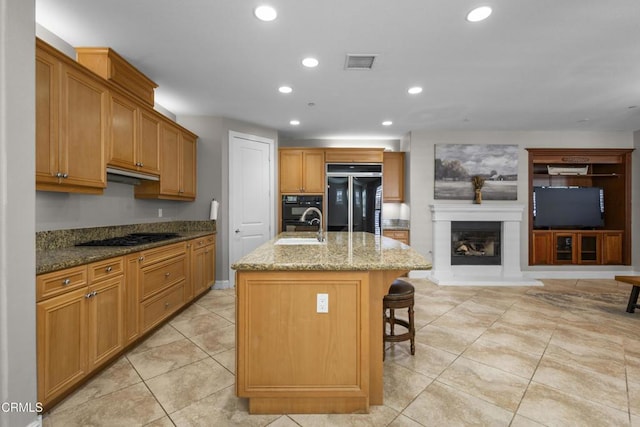 1315 Donegal Way, Oxnard, CA 93035 - kitchen featuring refrigerator, gas cooktop, recessed lighting, light stone countertops, and a glass covered fireplace