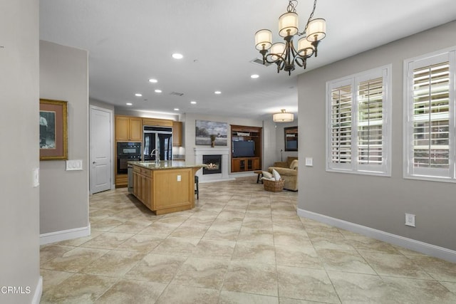 1315 Donegal Way, Oxnard, CA 93035 - kitchen featuring refrigerator, open floor plan, recessed lighting, oven, and a lit fireplace