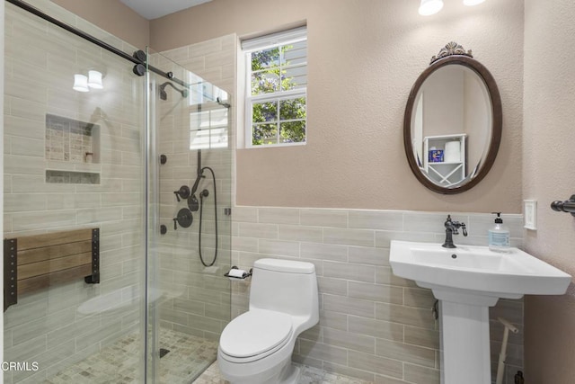 1315 Donegal Way, Oxnard, CA 93035 - bathroom featuring a shower stall, wainscoting, and tile walls