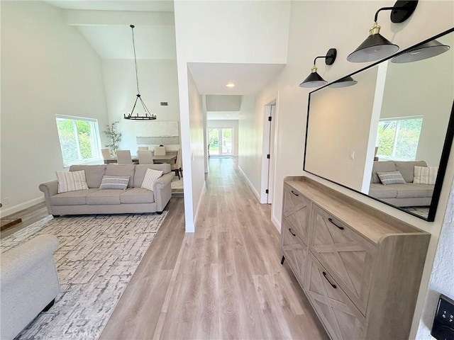 26871 Recodo Ln, Mission Viejo, CA 92691 - living area with high vaulted ceiling, healthy amount of natural light, baseboards, and light wood-style floors