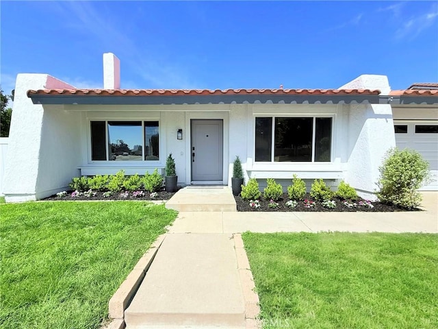 26871 Recodo Ln, Mission Viejo, CA 92691 - view of front of property with a front lawn, a tile roof, an attached garage, and stucco siding