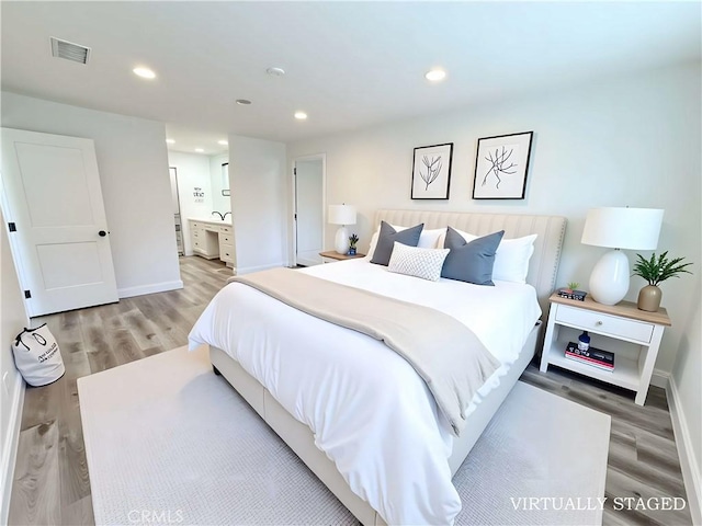 26871 Recodo Ln, Mission Viejo, CA 92691 - bedroom with light wood finished floors, baseboards, recessed lighting, and ensuite bath