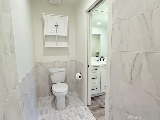 26871 Recodo Ln, Mission Viejo, CA 92691 - bathroom featuring tile walls, vanity, toilet, and wainscoting