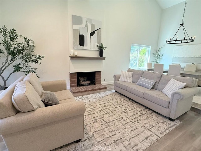 26871 Recodo Ln, Mission Viejo, CA 92691 - living area featuring high vaulted ceiling, wood finished floors, and a brick fireplace