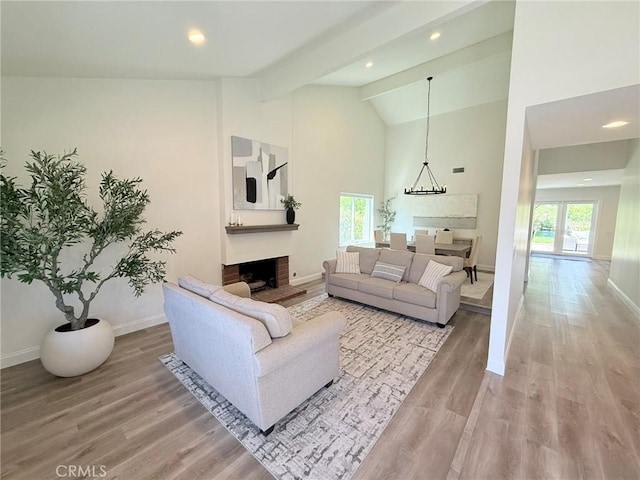 26871 Recodo Ln, Mission Viejo, CA 92691 - living room featuring light wood-style flooring, baseboards, high vaulted ceiling, a fireplace, and beam ceiling