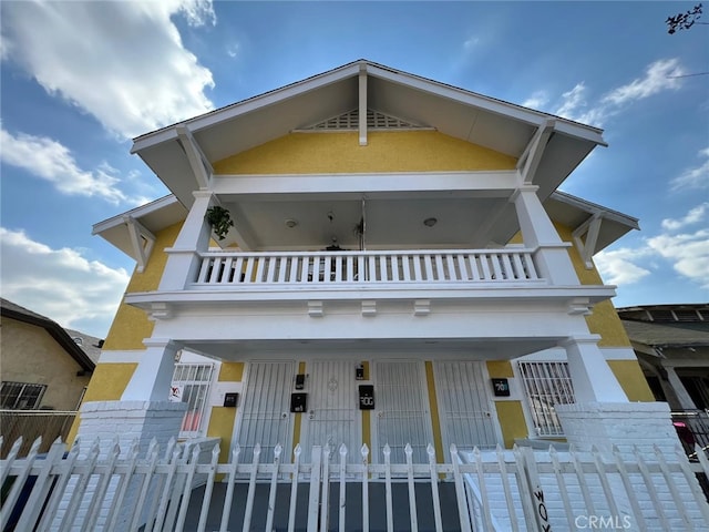 702 W Vernon Ave, Los Angeles, CA 90037 - view of front of property with a balcony, a fenced front yard, and a porch