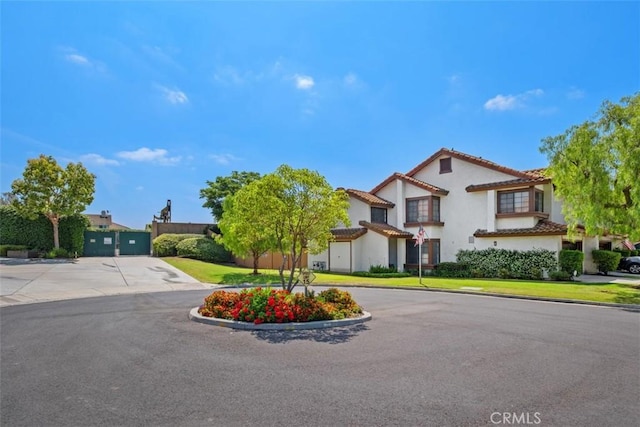 1132 Santiago Dr Unit 11, Placentia, CA 92870 - view of front facade with curved driveway, stucco siding, and a tiled roof