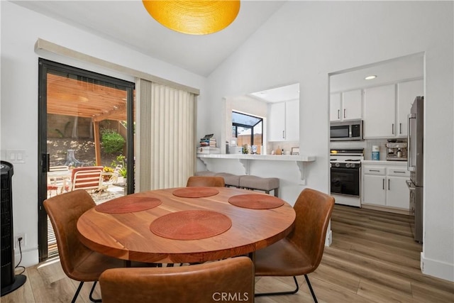1132 Santiago Dr Unit 11, Placentia, CA 92870 - dining room featuring light wood finished floors and high vaulted ceiling