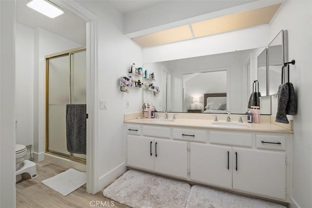 1132 Santiago Dr Unit 11, Placentia, CA 92870 - bathroom featuring a stall shower, wood finished floors, and double vanity
