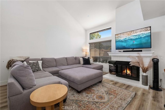 1132 Santiago Dr Unit 11, Placentia, CA 92870 - living room with wood finished floors, a glass covered fireplace, and high vaulted ceiling