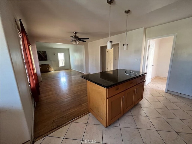 657 S Sadler Ave, East Los Angeles, CA 90022 - kitchen with a ceiling fan, light tile patterned floors, open floor plan, and hanging light fixtures