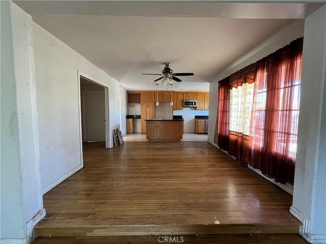657 S Sadler Ave, East Los Angeles, CA 90022 - unfurnished living room featuring dark wood-style floors, ceiling fan, and baseboards
