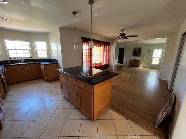 657 S Sadler Ave, East Los Angeles, CA 90022 - kitchen featuring a sink, dark countertops, light tile patterned flooring, a ceiling fan, and open floor plan