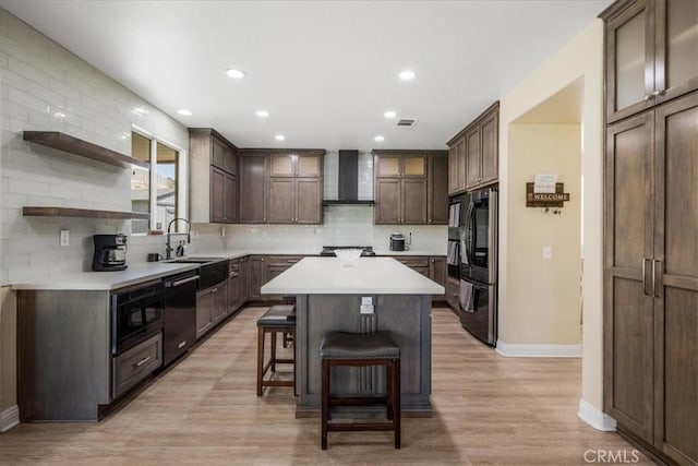 19454 Copper Ridge St, Perris, CA 92570 - kitchen with wall chimney exhaust hood, black appliances, a kitchen island, a kitchen breakfast bar, and tasteful backsplash