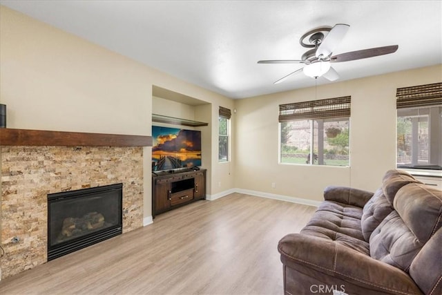 19454 Copper Ridge St, Perris, CA 92570 - living room featuring wood finished floors, healthy amount of natural light, ceiling fan, and a glass covered fireplace