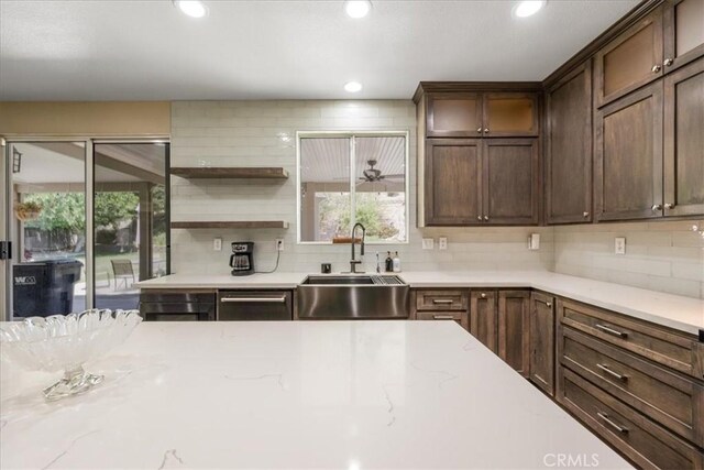 19454 Copper Ridge St, Perris, CA 92570 - kitchen featuring plenty of natural light, backsplash, recessed lighting, light stone countertops, and dark brown cabinetry