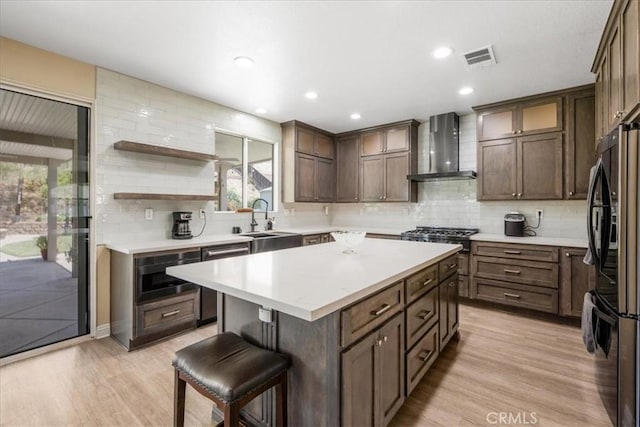 19454 Copper Ridge St, Perris, CA 92570 - kitchen featuring wall chimney exhaust hood, appliances with stainless steel finishes, light wood-style flooring, decorative backsplash, and recessed lighting