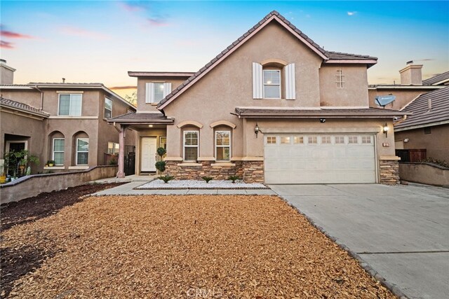 13279 Coffeetree St, Moreno Valley, CA 92553 - view of front of house featuring stucco siding, stone siding, driveway, and a garage