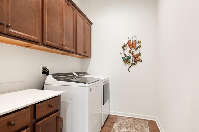 24190 Evesong Dr, Corona, CA 92883 - laundry room featuring washing machine and clothes dryer, cabinet space, and wood finished floors