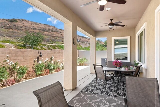 24190 Evesong Dr, Corona, CA 92883 - view of patio / terrace with a ceiling fan, outdoor dining area, and a mountain view